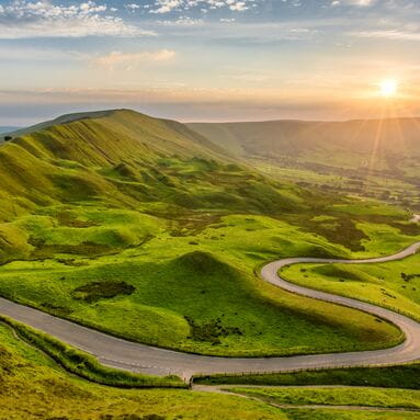 Road through grassy hills
