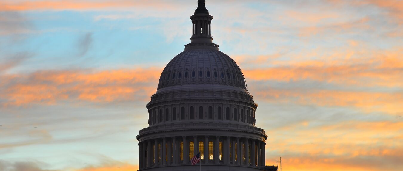 Capitol building dome silhouette in colorful sunrise, Washington D.C. United States